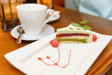 Tiramisu dessert and coffee on wooden table in cafe