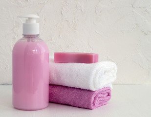 Fototapeta na wymiar Liquid soap and two towels on a white background.
