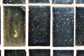 Rectangular black color old slab on the wall, grunge background texture