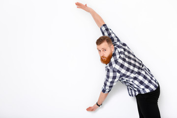 man with beard pointing copy space.