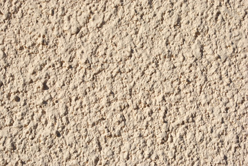 Wall with soft pink textured plaster, grunge background