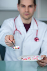 doctor giving pills on a dish