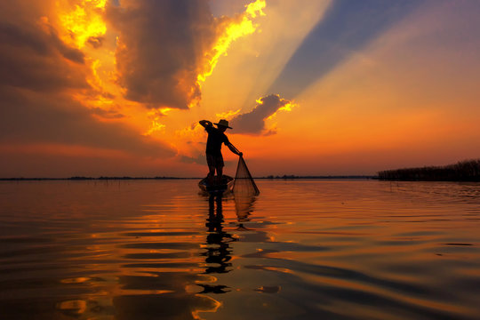 Silhouette fisherman with sunset,Take photo fisherman young woman with sunset