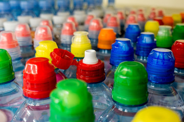 plastic bottles with water, color caps