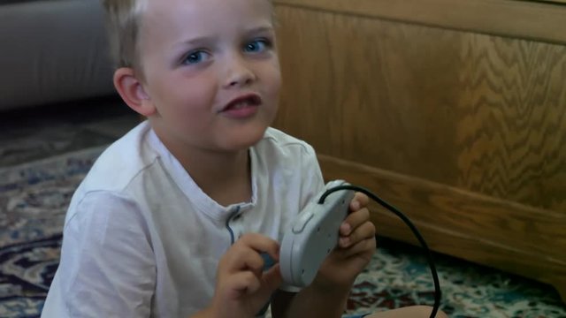 Little boy playing with a video game console