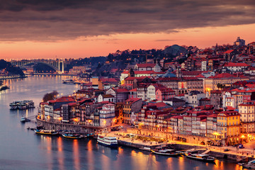 View to Porto over river Douro with reflection of the lights at night - obrazy, fototapety, plakaty