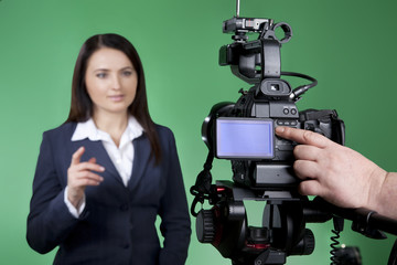Record interview on professional digital equipment. Television announcer isolated on green...