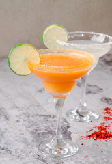 two classic and strawberry margarita, white and red alcoholic cocktail with salt on the edge of the glass, fresh lime, lemon, daiquiri on background restaurant. Bar alcohol menu, sweet drink