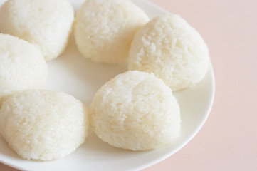 Fototapeta na wymiar Onigiri, also known as omusubi, nigirimeshi or rice ball, is a Japanese food made from white rice formed into triangular or cylindrical shapes.