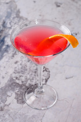 Top view red orange cocktail Margarita fresh in a martini glass on a gray background. Bar alcohol drink menu, delicious tequila sunrise long drink.