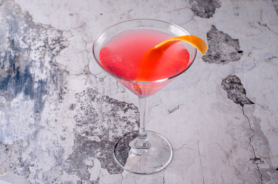 Top View Red Orange Cocktail Margarita Fresh In A Martini Glass On A Gray Background. Bar Alcohol Drink Menu, Delicious Tequila Sunrise Long Drink.