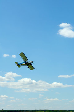small sport plane flying in the sky