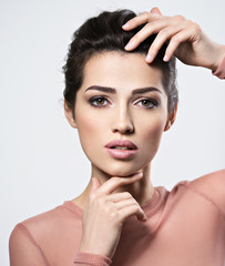 Fototapeta premium Portrait of an young beautiful woman with smoky eyes makeup.