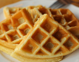 plain waffles served on plate for breakfast close up top photo