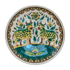 Covered with glaze ceramic plate handmade. Isolated on a white background