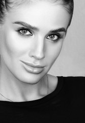 Fototapeta premium Black and white closeup beauty portrait of beautiful young woman with professional colourful make-up