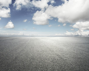 Empty road with cloudy sky background - obrazy, fototapety, plakaty