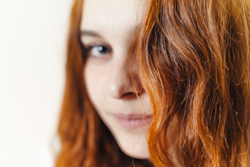 Beautiful, healthy, long, curly, red hair dyed with henna. Professional hair care.