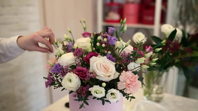 Close up of woman florist making bouquet at flower shop. People, small business, sale and floristry concept.