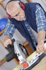 carpenter with power grinder