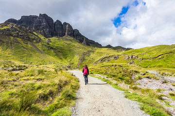An hiker on the footpath to the famous rock Old Man of Storr, Isle of Skye, Scotland, Britain