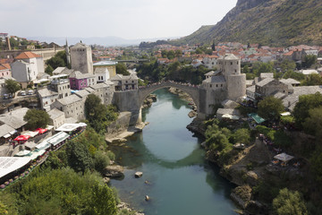 Fototapeta na wymiar View from the top of the city of Mostar and its famous bridge in a sunny day in summer season