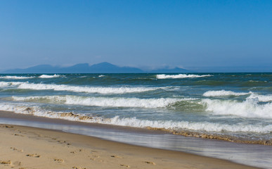 An Bang Beach looking across the South China Sea towards the mountains near Danang, Vietnam