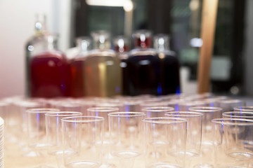 bottles with homemade tinctures and glasses on the table
