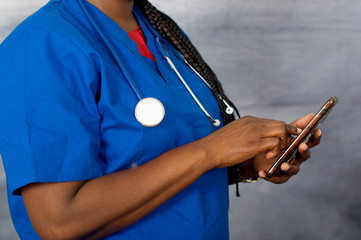 close up of female doctor hand handling mobile phone