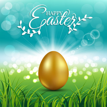Gold egg on fresh spring grass for Easter day greeting card