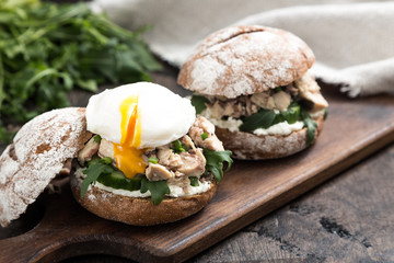 Food burger with tuna, herbs, cucumbers, cottage cheese, onions
