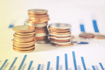 Graph on rows of coins for finance and banking on digital stock market financial exchange and Trading graph Double exposure city on the background