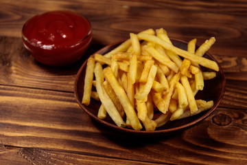 French fries with ketchup on wooden table