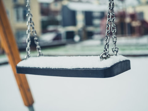 Swing on playground in the snow
