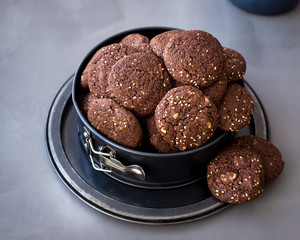 On the metal form, chocolate biscuits with sesame