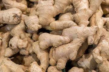 Fresh organic ginger root in supermarket, background