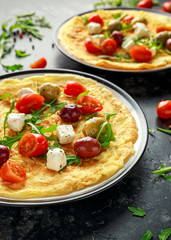 Vegetables Eggs Omelette with tomatoes, wild rocket, greek cheese, olives in a plate. Morning breakfast. healthy food