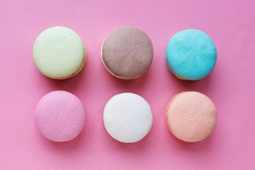six macarons cakes on pink background