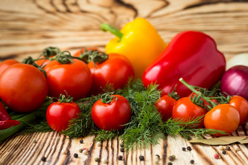 Composition with assorted raw organic vegetables such as tomatoes, sweet peppers, herbs, onions and garlic. Detox diet