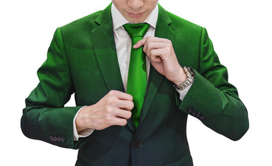 Businessman in green suit tying green necktie, isolated on white background