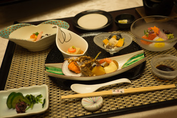 A traditional Japanese dinner also known as Keiseki being served at a Ryokan or traditional Japanese hotel