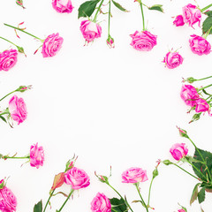 Floral frame made of pink roses, branches and leaves on white background. Flat lay, Top view. Valentines day composition