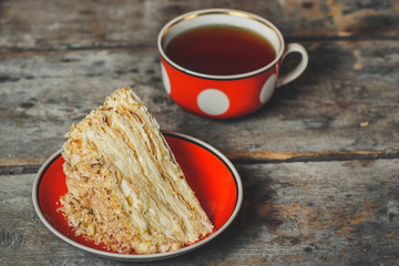 cake - Napoleon (puff cake with white cream) on a wooden table