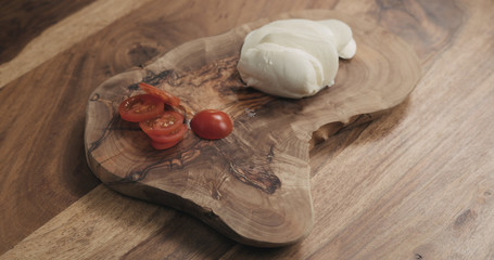 sliced cherry tomato on wooden board
