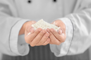 Female chef holding white wheat flour, closeup