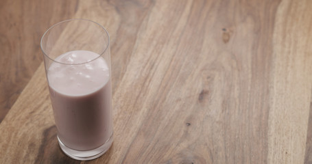strawberry yogurt in a glass on wood table
