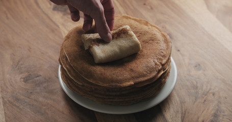 closeup of folding pancake with sour cream