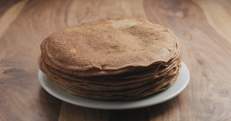 stack of fresh pancakes on wooden table
