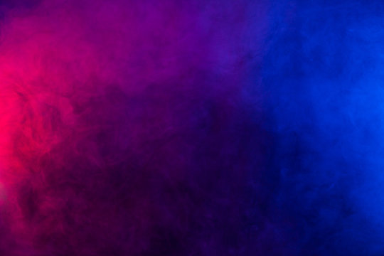 Blue and violet smoke texture on a black background. Texture and abstract art