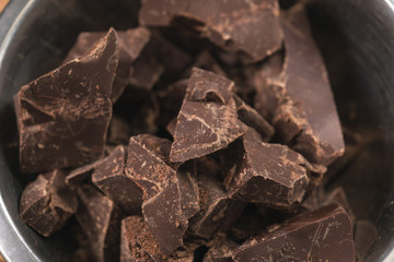 melting dark chocolate chunks in steel bowl